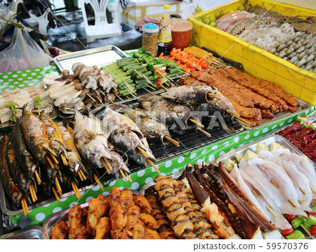 Freshly made marine products, seafood, fish and meat on the shelves of a street vendor kiosk, Phuket, Thailand Freshly made marine products, seafood, fish and meat on the shelves of a street vendor kiosk, Phuket, Thailand 59570376