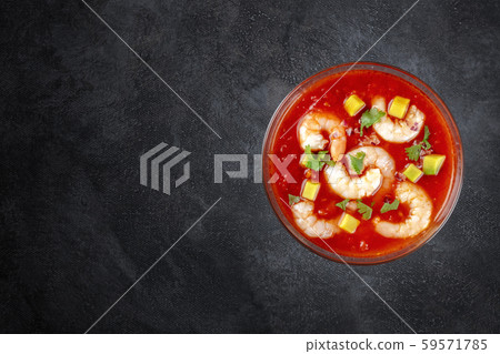 Coctel de camarones, Mexican prawn cocktail with avocado, top-down shot on a dark background with a Coctel de camarones, Mexican prawn cocktail with avocado, top-down shot on a dark background with a 59571785
