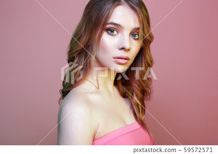 Beautiful young blond woman in pink Beautiful young blond woman in pink 59572571