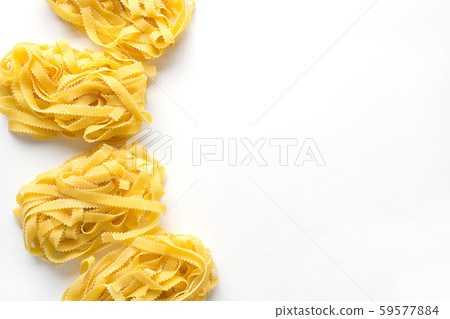 Tasty pasta shape reginelle on white. View from above. 59577884