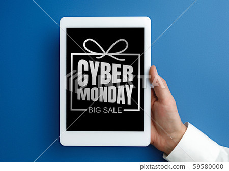 Male hand holding tablet with cyber monday words on blue background 59580000