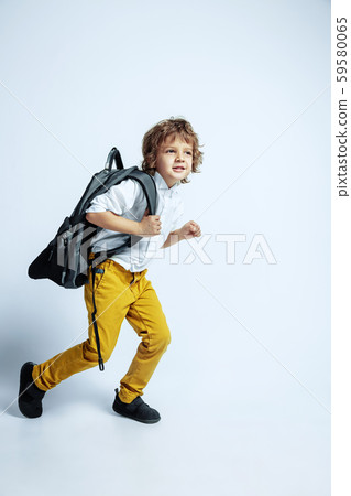 Pretty young boy in casual clothes on white studio background 59580065
