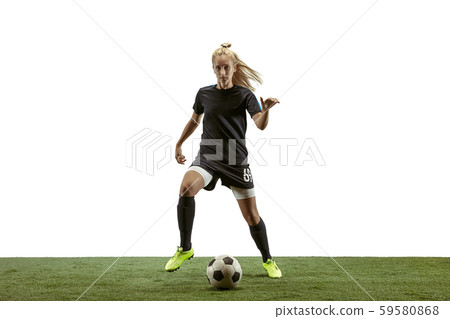 Female soccer player kicking ball at the stadium 59580868