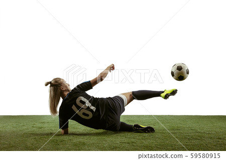 Female soccer player kicking ball at the stadium Female soccer player kicking ball at the stadium 59580915