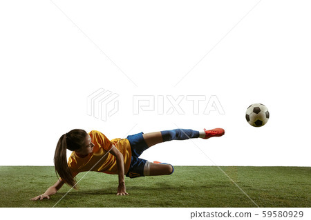 Female soccer player kicking ball at the stadium Female soccer player kicking ball at the stadium 59580929