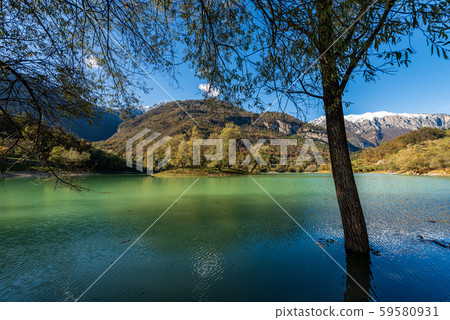 Lake Tenno with island and Giudicarie Alps with snow - Trentino Italy Lake Tenno with island and Giudicarie Alps with snow - Trentino Italy 59580931