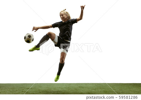 Female soccer player kicking ball at the stadium Female soccer player kicking ball at the stadium 59581286