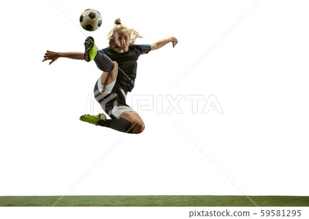 Female soccer player kicking ball at the stadium 59581295