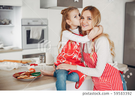 Family sitting in a kitchen with cookies 59583392