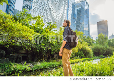 Young man tourist in Cheonggyecheon stream in Seoul, Korea. Cheonggyecheon stream is the result of a 59583999
