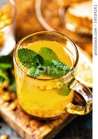 Sea buckthorn tea. Hot healing berry drink for the Sea buckthorn tea. Hot healing berry drink for the 59584261