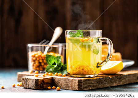 Sea buckthorn tea. Hot healing berry drink for the Sea buckthorn tea. Hot healing berry drink for the 59584262