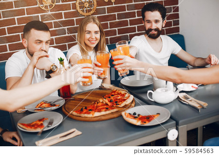 Cute friends in a cafe eatting a pizza 59584563