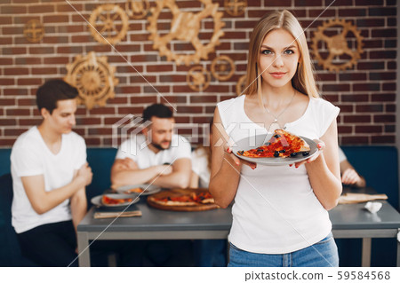 Cute friends in a cafe eatting a pizza 59584568