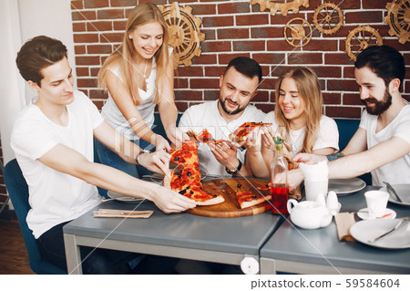 Cute friends in a cafe eatting a pizza 59584604