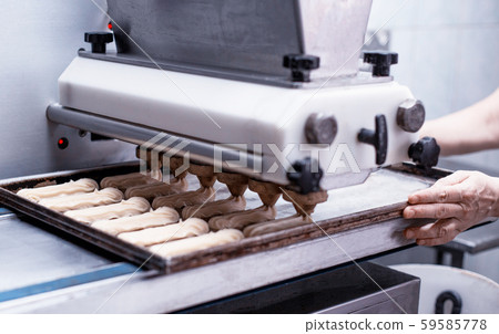 Automatic line for the production of eclairs. Eclair Cake Dough Baking, preparation Automatic line for the production of eclairs. Eclair Cake Dough Baking, preparation 59585778