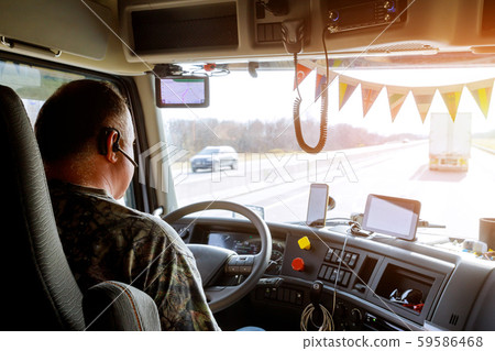 Driver in cabin of big modern truck 59586468