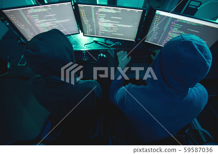 Hackers working together at office Hackers working together at office 59587036