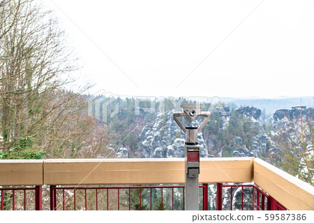 Binocular on observation deck aimed at mountains 59587386