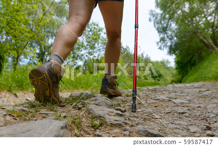 Traveler legs, woman is walking on the path Traveler legs, woman is walking on the path 59587417