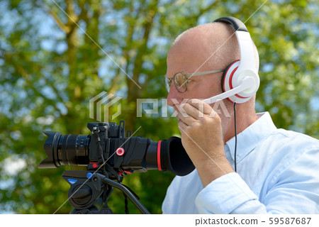 man with headphones, using a camera dslr man with headphones, using a camera dslr 59587687