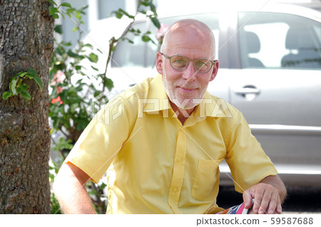 Portrait of a mature man relaxing in the garden Portrait of a mature man relaxing in the garden 59587688