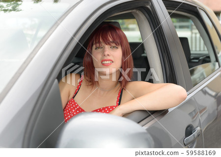 Smiling woman sitting in car 59588169