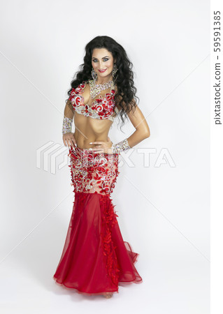 Girl in a red dress for oriental dancing. Girl in a red dress for oriental dancing. 59591385