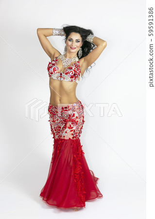 Girl in a red dress for oriental dancing. Girl in a red dress for oriental dancing. 59591386