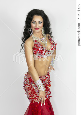 Girl in a red dress for oriental dancing. Girl in a red dress for oriental dancing. 59591389