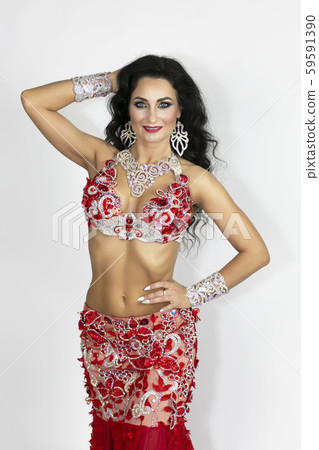 Girl in a red dress for oriental dancing. Girl in a red dress for oriental dancing. 59591390