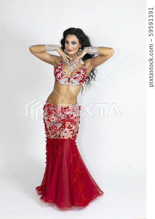Girl in a red dress for oriental dancing. Girl in a red dress for oriental dancing. 59591391