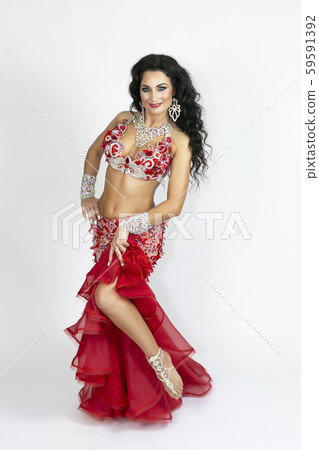 Girl in a red dress for oriental dancing. Girl in a red dress for oriental dancing. 59591392