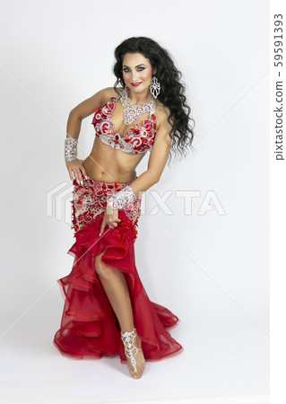 Girl in a red dress for oriental dancing. Girl in a red dress for oriental dancing. 59591393