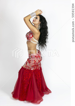 Girl in a red dress for oriental dancing. Girl in a red dress for oriental dancing. 59591394