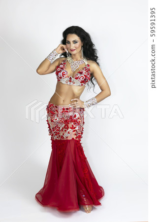 Girl in a red dress for oriental dancing. 59591395