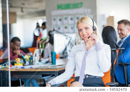 Cheerful young blonde customer service operator at call center Cheerful young blonde customer service operator at call center 59592470