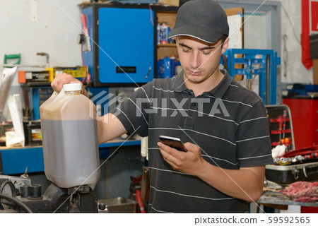 Portrait of a young mechanic in his workshop Portrait of a young mechanic in his workshop 59592565