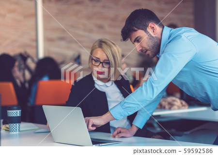 Happy business partners working on laptop. Teamwork, co-working concepts. Happy business partners working on laptop. Teamwork, co-working concepts. 59592586
