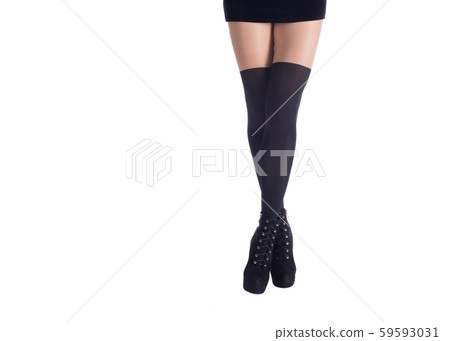 Long sexy female legs in black gaiters, fitting dress and ankle boots, isolated on white. Woman 59593031