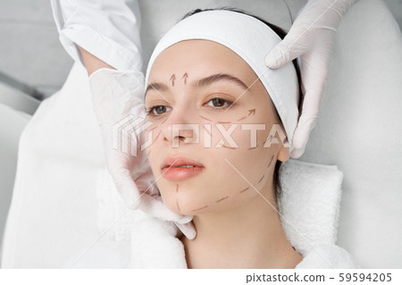 Woman with black surgical marks for correction. Woman with black surgical marks for correction. 59594205