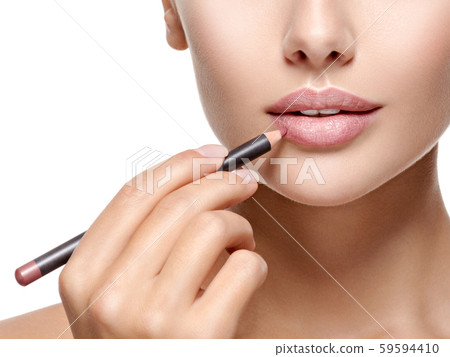Beautiful woman applying lipstick with cosmetic 59594410