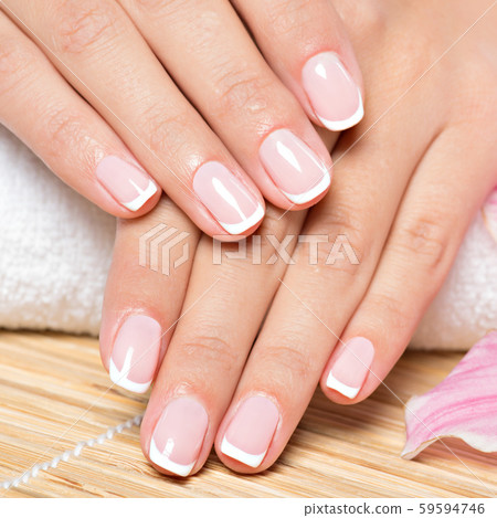 Beautiful woman's nails with french manicure Beautiful woman's nails with french manicure 59594746