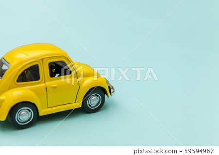 Yellow vintage retro toy car isolated on blue 59594967