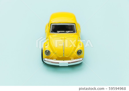 Yellow vintage retro toy car isolated on blue 59594968
