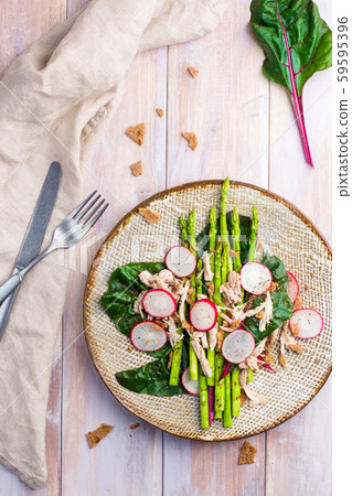 Asparagus salad with chicken, radish, beet leafs and rye crumb 59595396