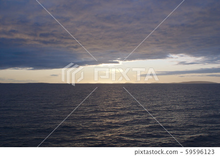 Image of the sunset hidden by clouds over the sea Image of the sunset hidden by clouds over the sea 59596123
