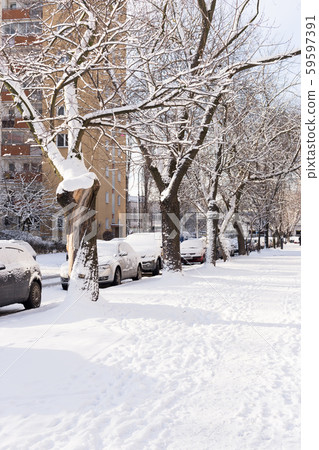 Sidewalk and cars in snow in a typical Polish town in winter 59597391