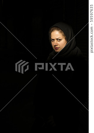 Low key portrait of a young Muslim woman 59597635