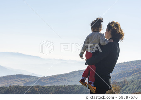 Young mother with little daughter looking at Young mother with little daughter looking at 59597676